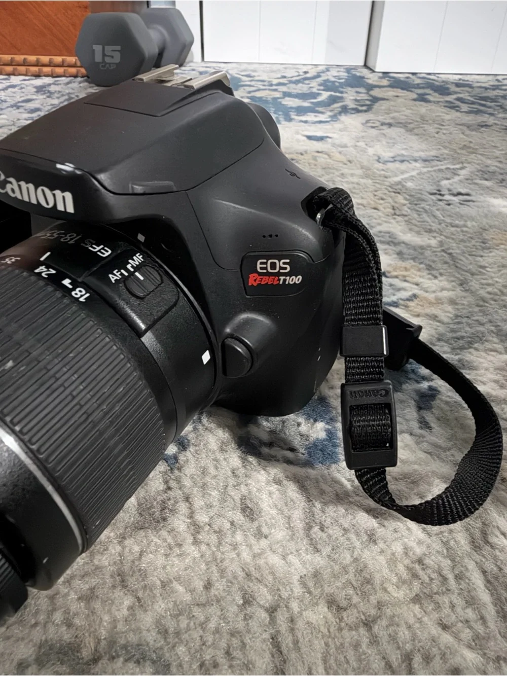 Canon EOS RebelT100 DSLR Camera with Kit Zoom Lens and Red-Trim Strap